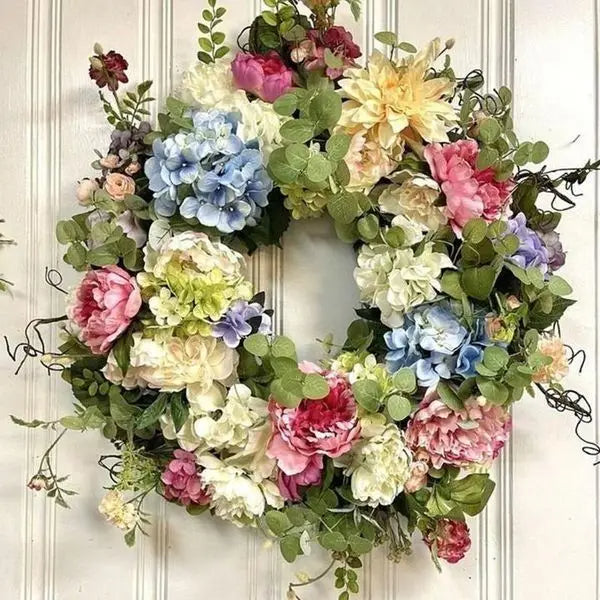 Vibrant artificial hydrangea wreath, perfect for front door decor. Features colorful rainbow florals for a welcoming home accent.