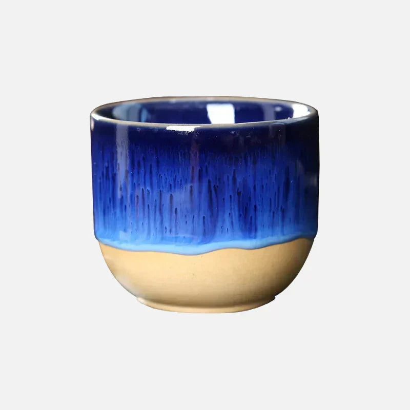Vibrant ceramic tea cup with artistic splatter design, perfect for home decor.
