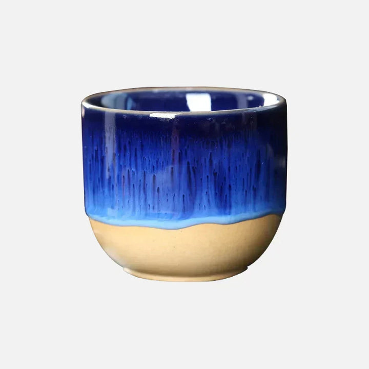 Vibrant ceramic tea cup with artistic splatter design, perfect for home decor.