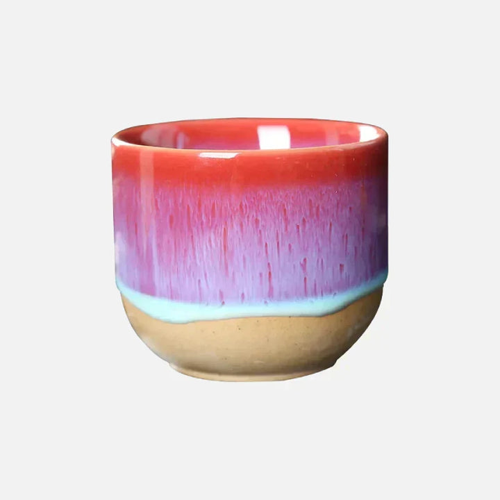 Handcrafted ceramic tea cup, colorful splatter design, ideal for daily use.