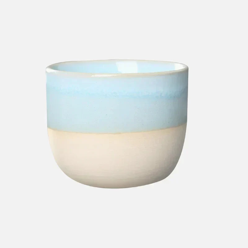 Colorful ceramic drinkware, a unique tea cup with a bold splatter finish.