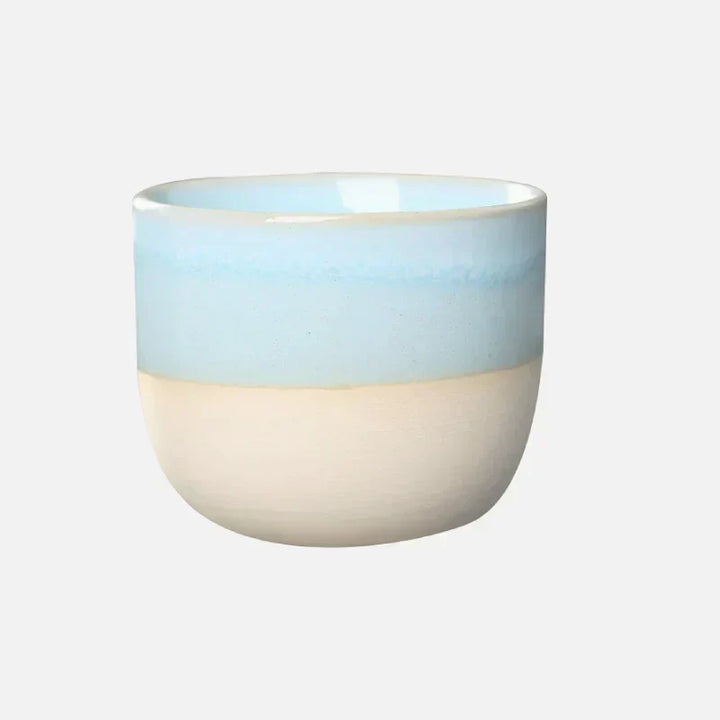 Colorful ceramic drinkware, a unique tea cup with a bold splatter finish.
