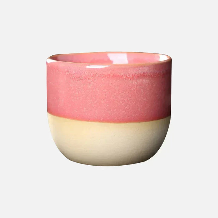 Durable ceramic tea cup with an artistic, vibrant splatter glaze, kitchen essential.