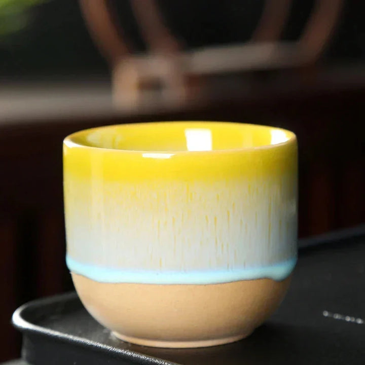 Unique colorful ceramic coffee mug featuring a bold splatter pattern.