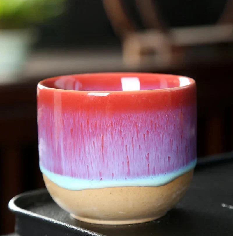 Close-up of a colorful ceramic tea cup with a unique splatter art design.