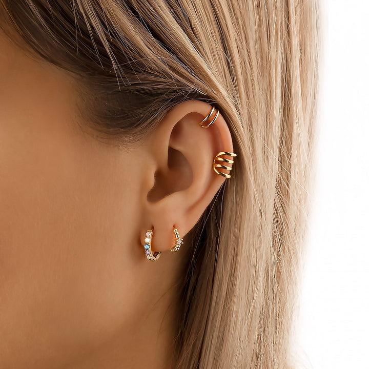 Gold plated sterling silver huggie earrings with colorful zirconia, a stylish statement piece for women.