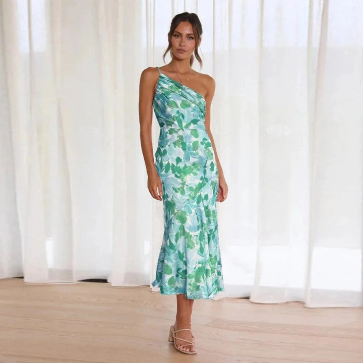 Flowy women's floral midi dress, vibrant colors, sleeveless, features a stylish asymmetric hem for summer.