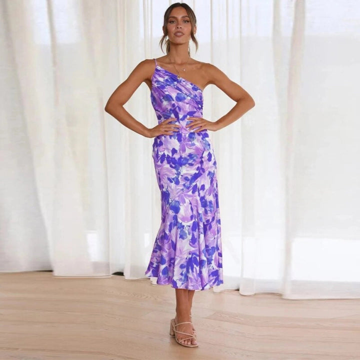 Stylish women's midi dress, sleeveless, vibrant floral print, elegant asymmetric flowy hem for summer wear.