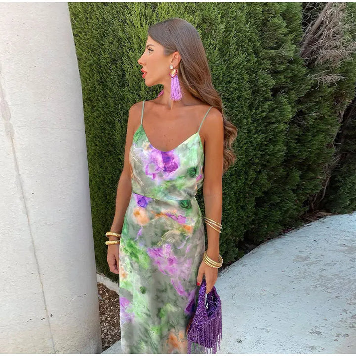 Women's comfortable flowy halo-dye maxi dress. Features a vibrant, colorful print and versatile detachable scarf.