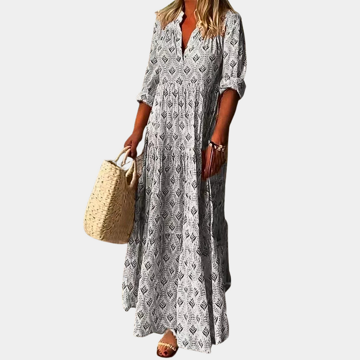 Women's Isla breezy flowing maxi dress in a vibrant print, ideal for casual summer days or beach trips.