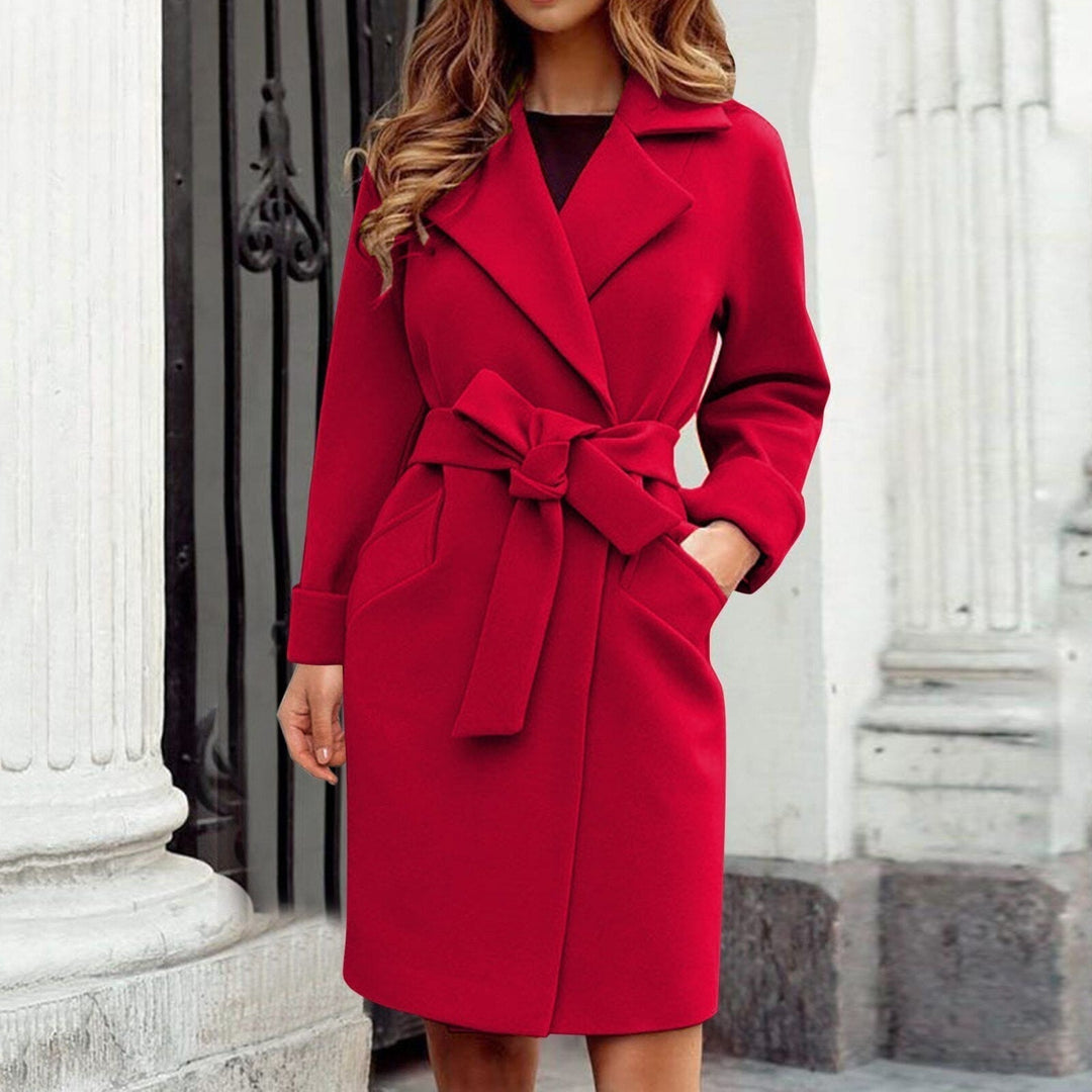Warm women's long winter trench coat, designed with a vibrant color and elegant button details, for stylish ladies.