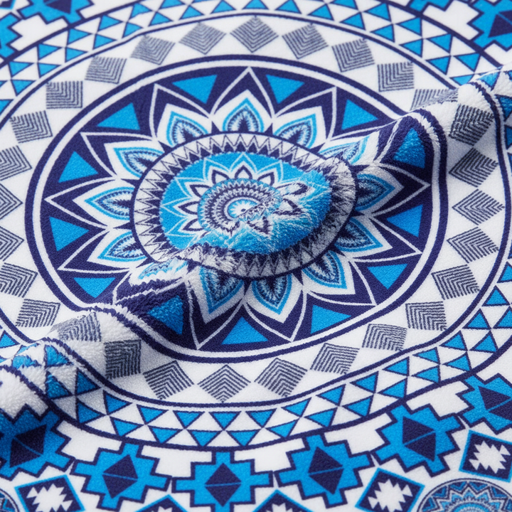 Unisex vibrant mandala beach towel, spread out on sand, lively colors for beach or picnic
