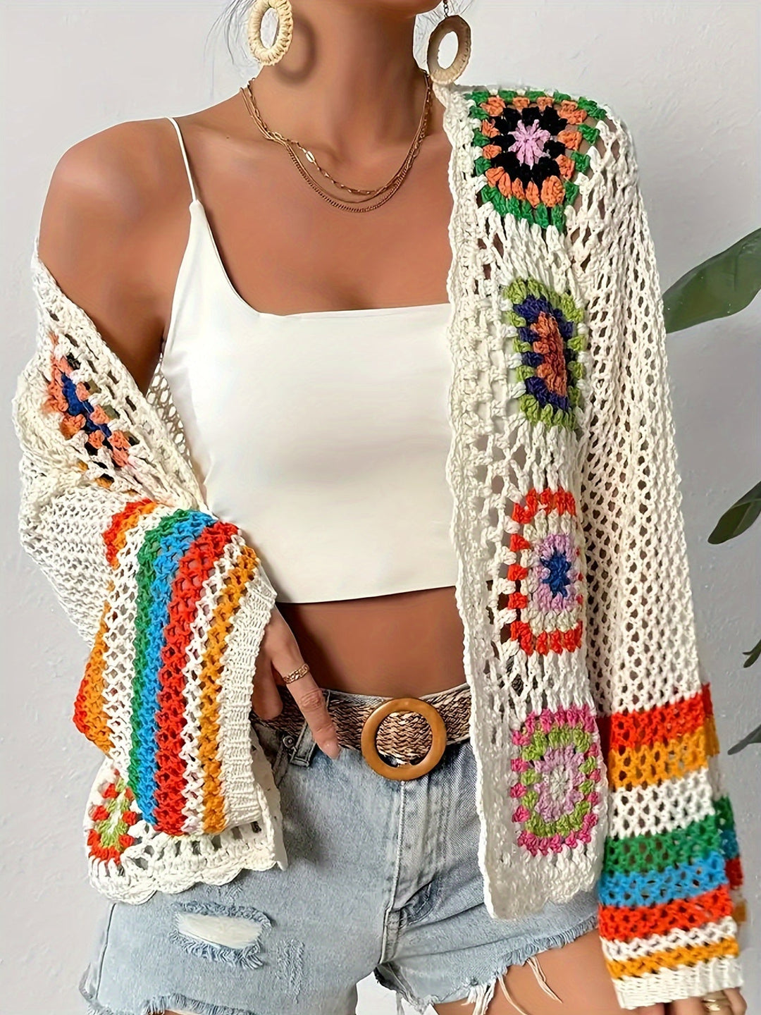 Statement women's vibrant mosaic crochet cardigan, showcasing intricate patterns & elegant bell sleeves. A unique top.