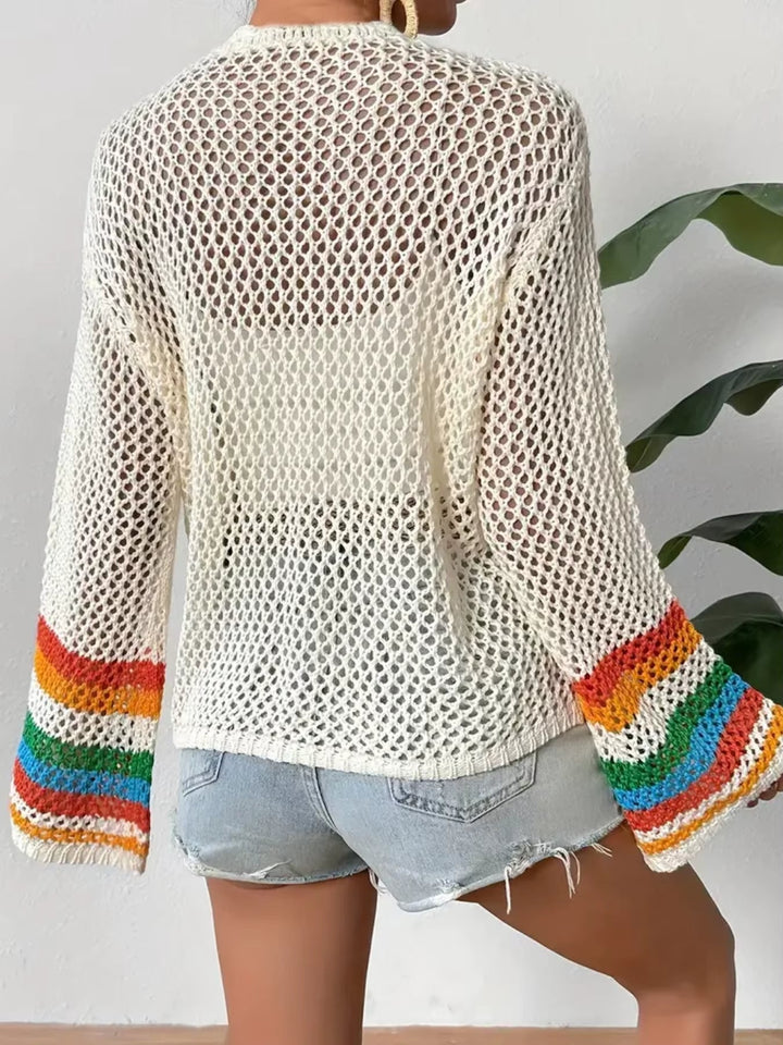 Close-up of a women's vibrant mosaic crochet cardigan, highlighting the intricate pattern and chic bell sleeve detail.