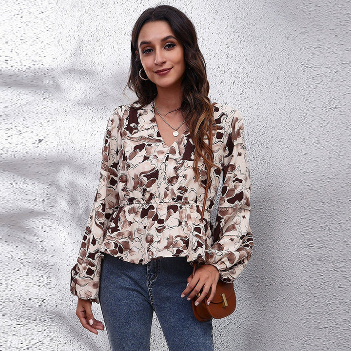Back view of a women's colorful patterned blouse, displaying its relaxed fit & versatile design. Summer fashion.
