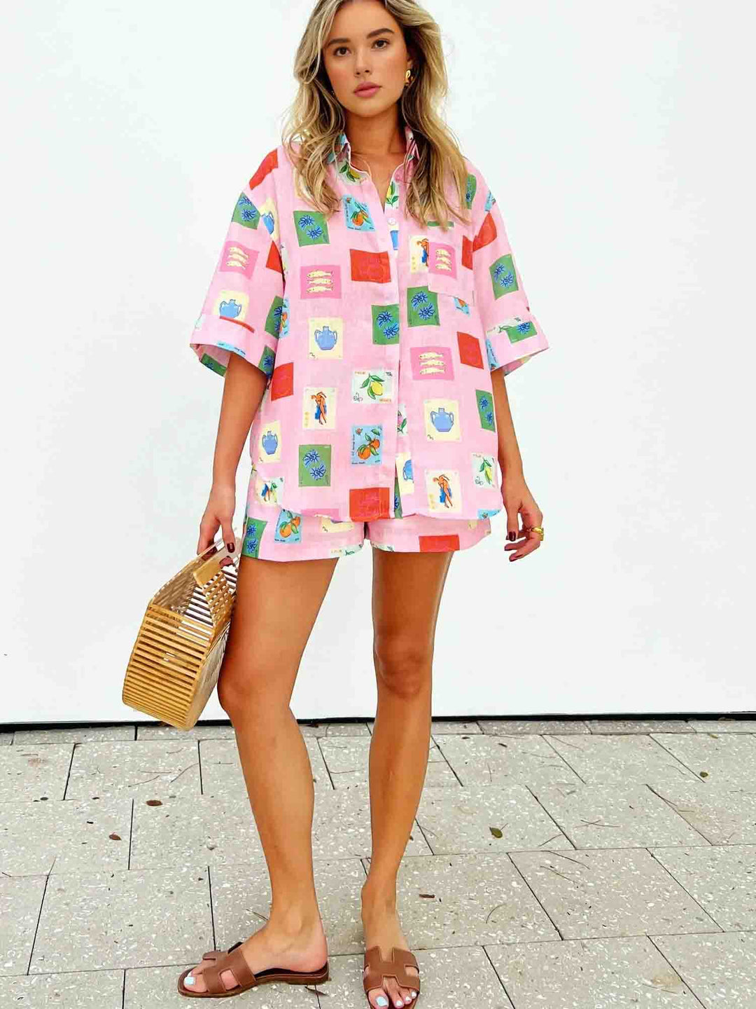 Full view of a woman wearing a stylish floral blouse and shorts summer set, comfortable and fashionable