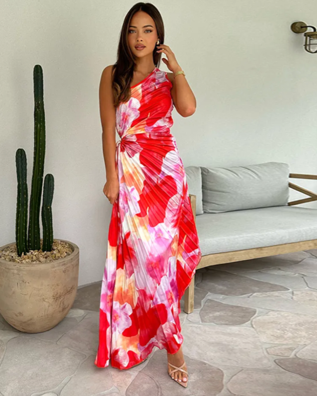 Vibrant printed one-shoulder gown for women, featuring a flowy asymmetric hem. Perfect for wedding guests.