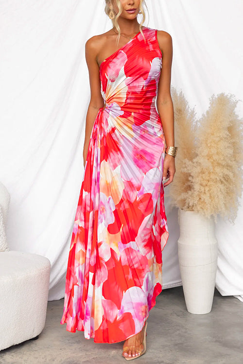 Women's elegant one-shoulder gown with vibrant floral print & asymmetric hem. Ideal for special occasion guests.