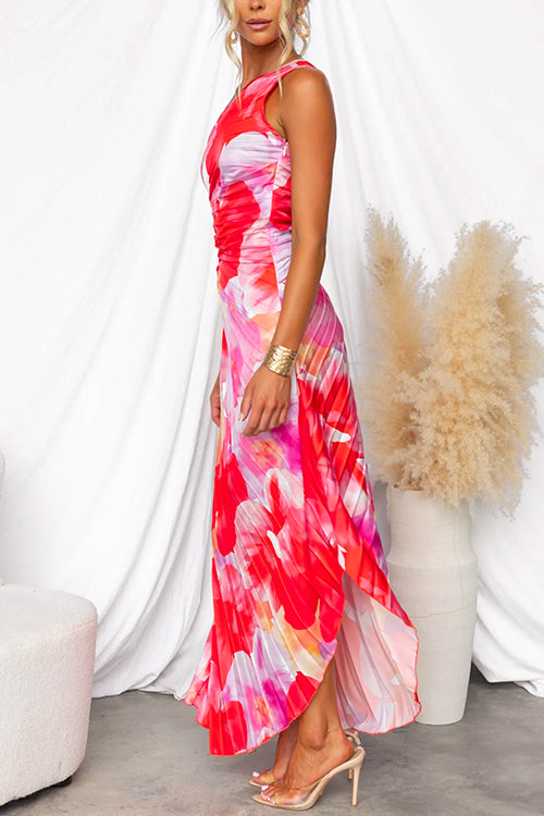 Pleated one-shoulder gown for women in a vibrant pattern, with an asymmetric hem. Great for summer wedding guests.