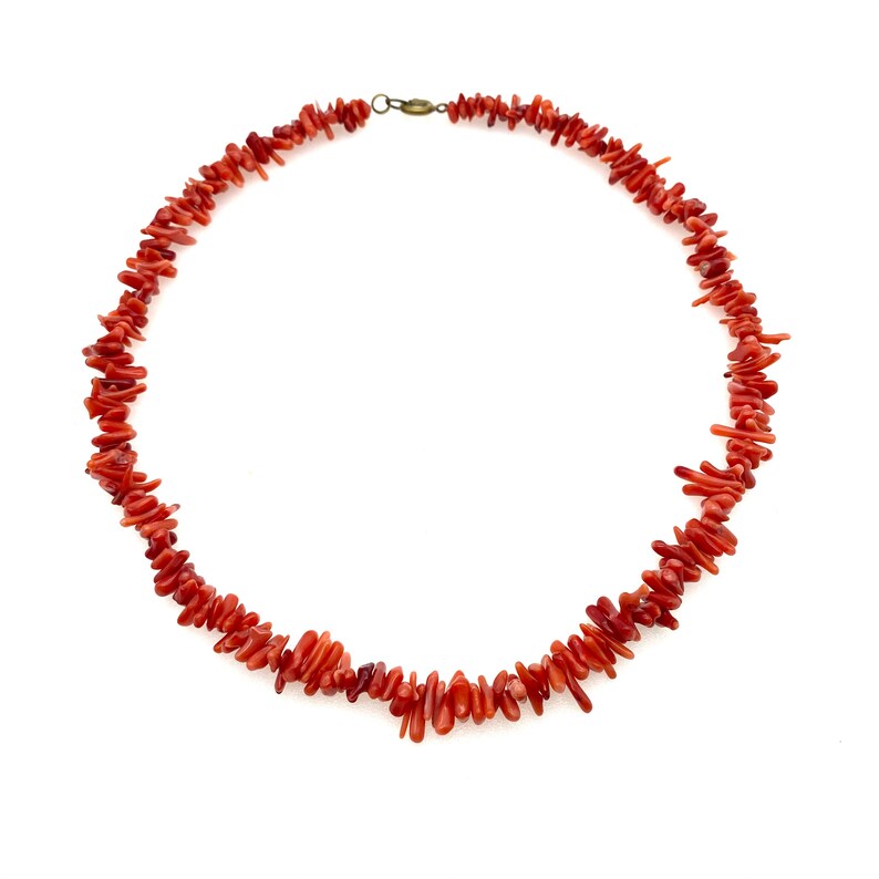 Vibrant red coral bead necklace for women. Stunning beaded gemstone jewelry, perfect as a fashion statement accessory.