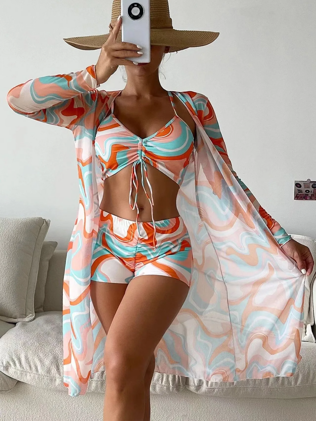 Summer fashion essential: women's vibrant 3-piece swim set with mesh cover-up for beach & pool style.