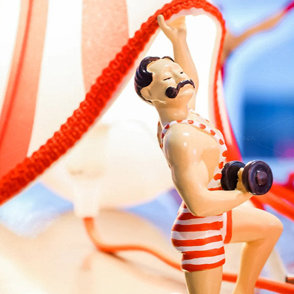 Decorative vintage circus strongman lamp, novelty accent light for quirky home decor.