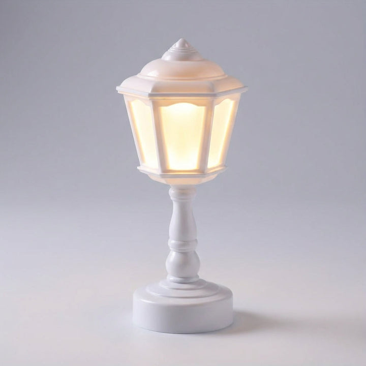 Compact vintage LED lantern lamp offering warm ambient lighting, perfect as a night light on a table.