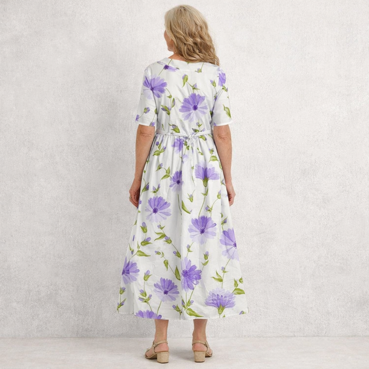 Women's elegant violet maxi dress featuring a vintage floral print, Peter Pan collar & tie waist.