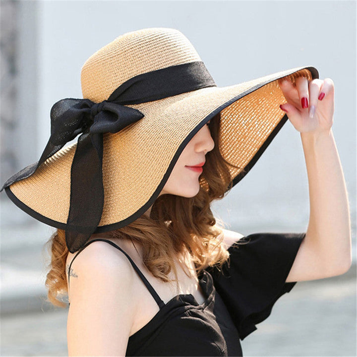 Vivian women's wide-brim sun hat in natural straw, perfect for beach UV protection.