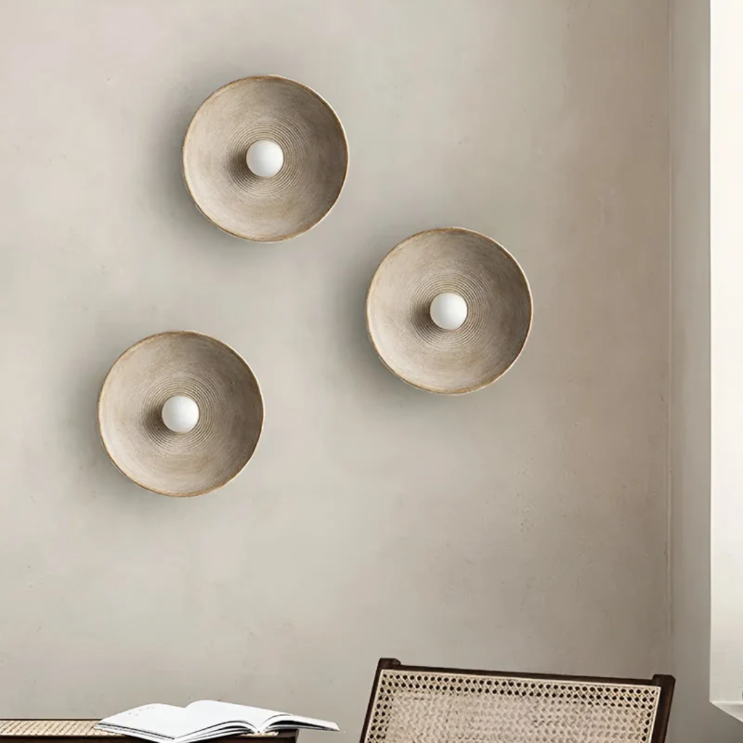 Elegant Wabi-Sabi disc wall lamp in a minimalist modern style, crafted from resin and glass.