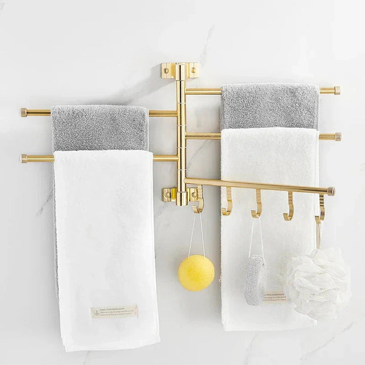 Bathroom wall decor: Gold finish triple arm towel rack, offering practical and chic towel storage.