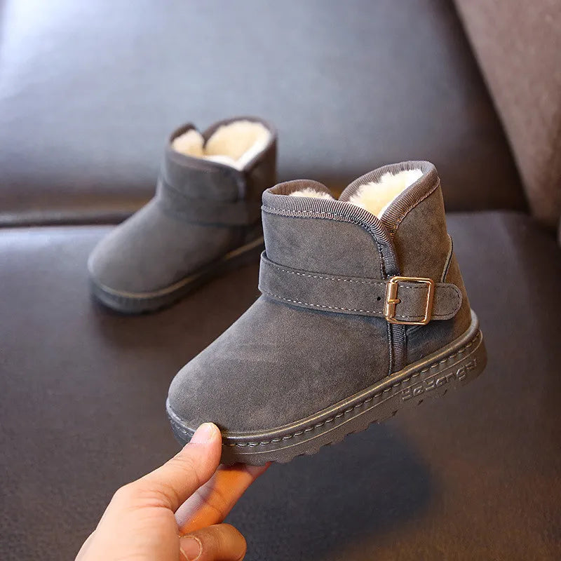 Pair of black kids' winter footwear, snow boots with durable, non-slip soles for boys and girls.