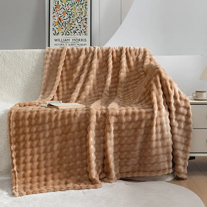 Close-up of a cozy flannel blanket showing its plush texture, highlighting its warmth and softness.