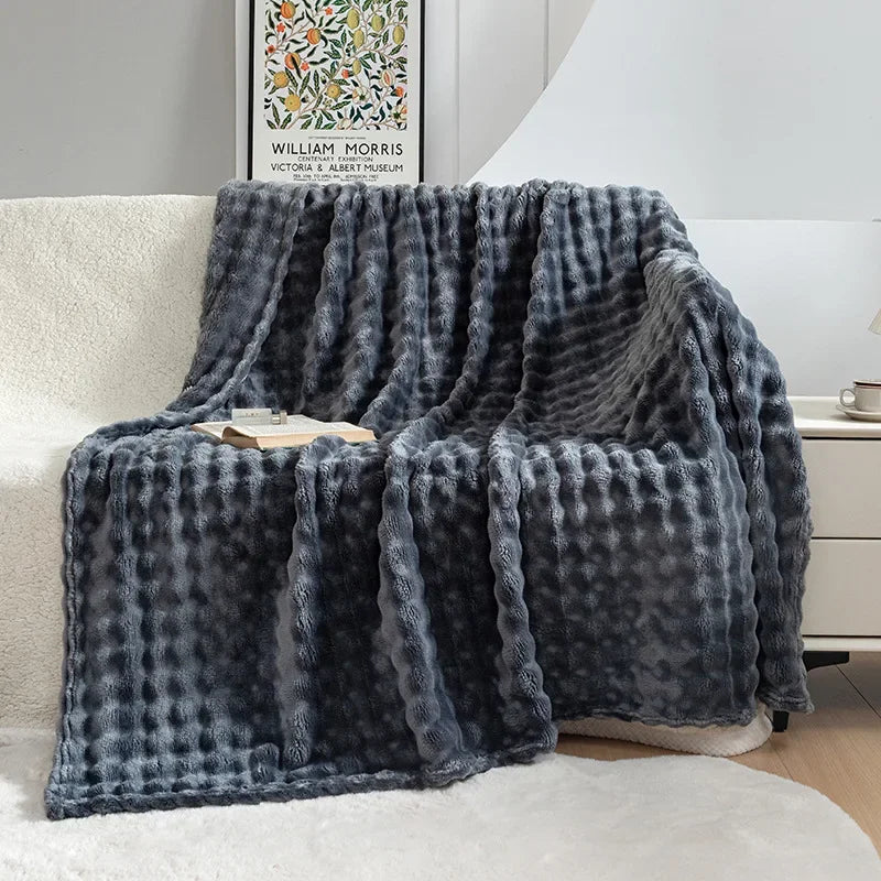 Unisex warm blanket, a plush flannel throw draped invitingly, adding comfort to any home.