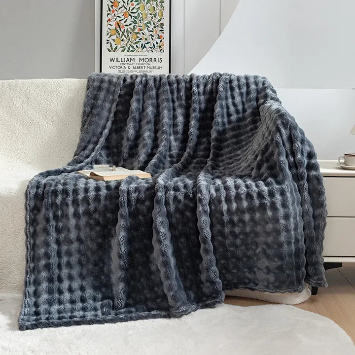 Unisex warm blanket, a plush flannel throw draped invitingly, adding comfort to any home.