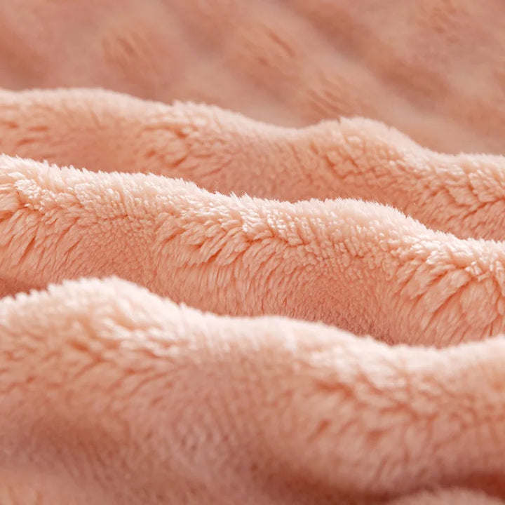 Stylish textured blanket made of soft flannel, perfect for cozying up on a bed or sofa.