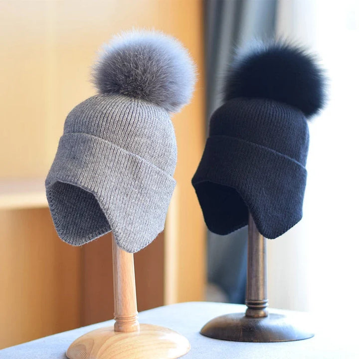 Warm grey knit alpine pom beanie for cold weather. Stylish unisex winter hat accessory, cozy & comfortable.