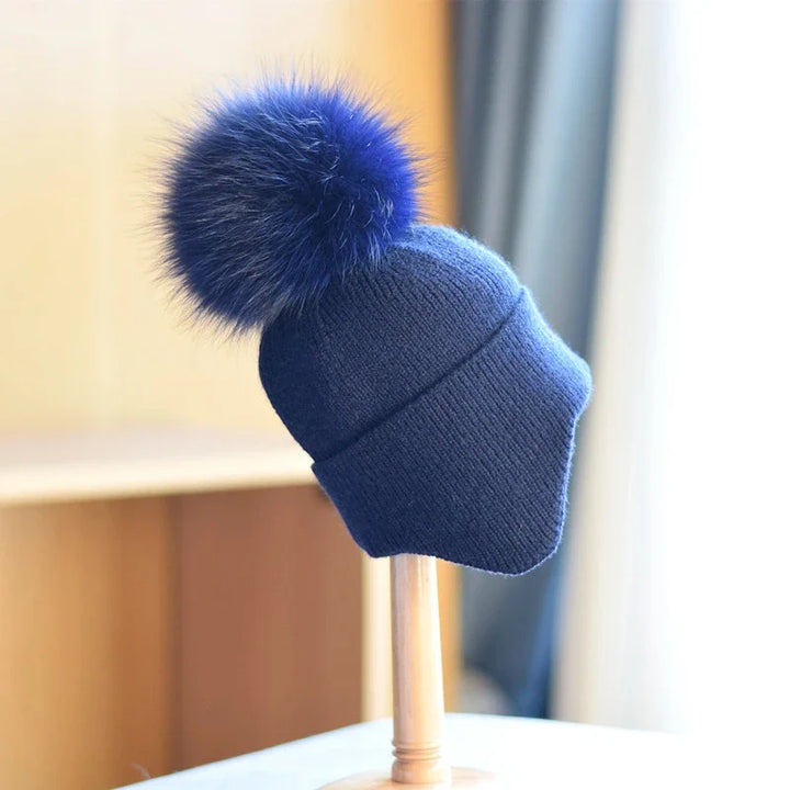 Unisex alpine pom beanie. Warm knit hat for cold weather, a stylish and essential winter accessory.