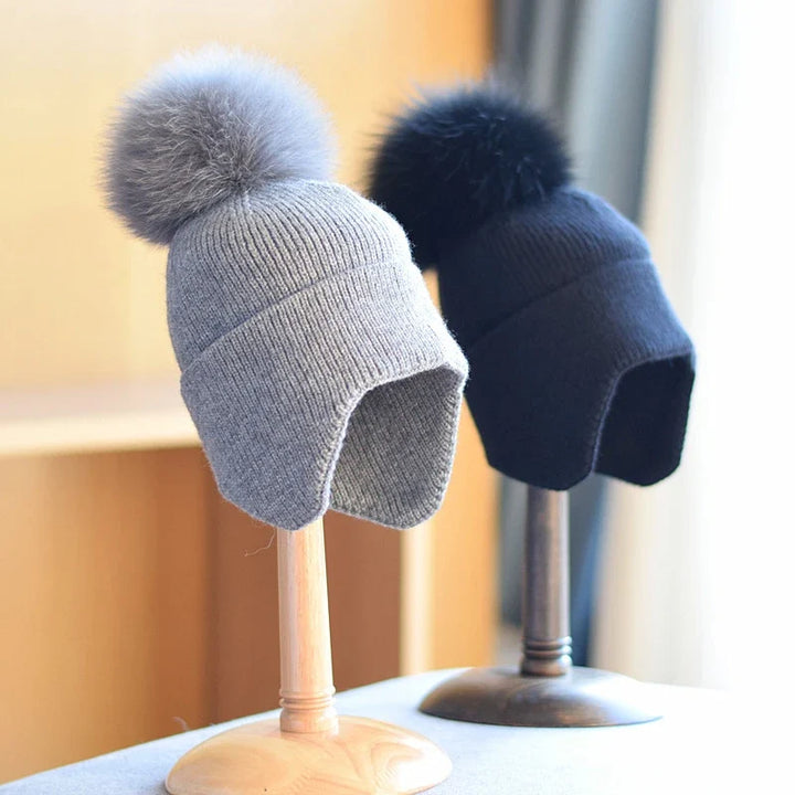 Soft knit alpine pom beanie. Stylish unisex winter hat accessory, keeps you warm in cold weather.