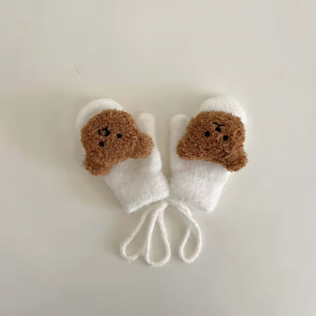Close-up of a knitted baby mitten showing soft texture and connecting strap.