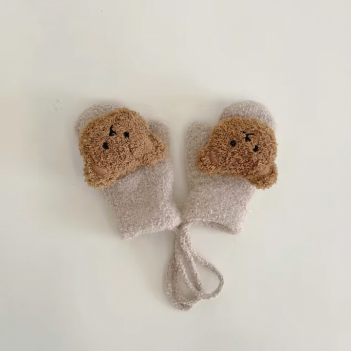Newborn baby mittens, knitted, in white, with a convenient connecting strap.