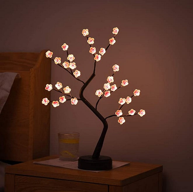 Illuminated plum blossom light tree with flexible branches, perfect as an ambient lamp or night light.