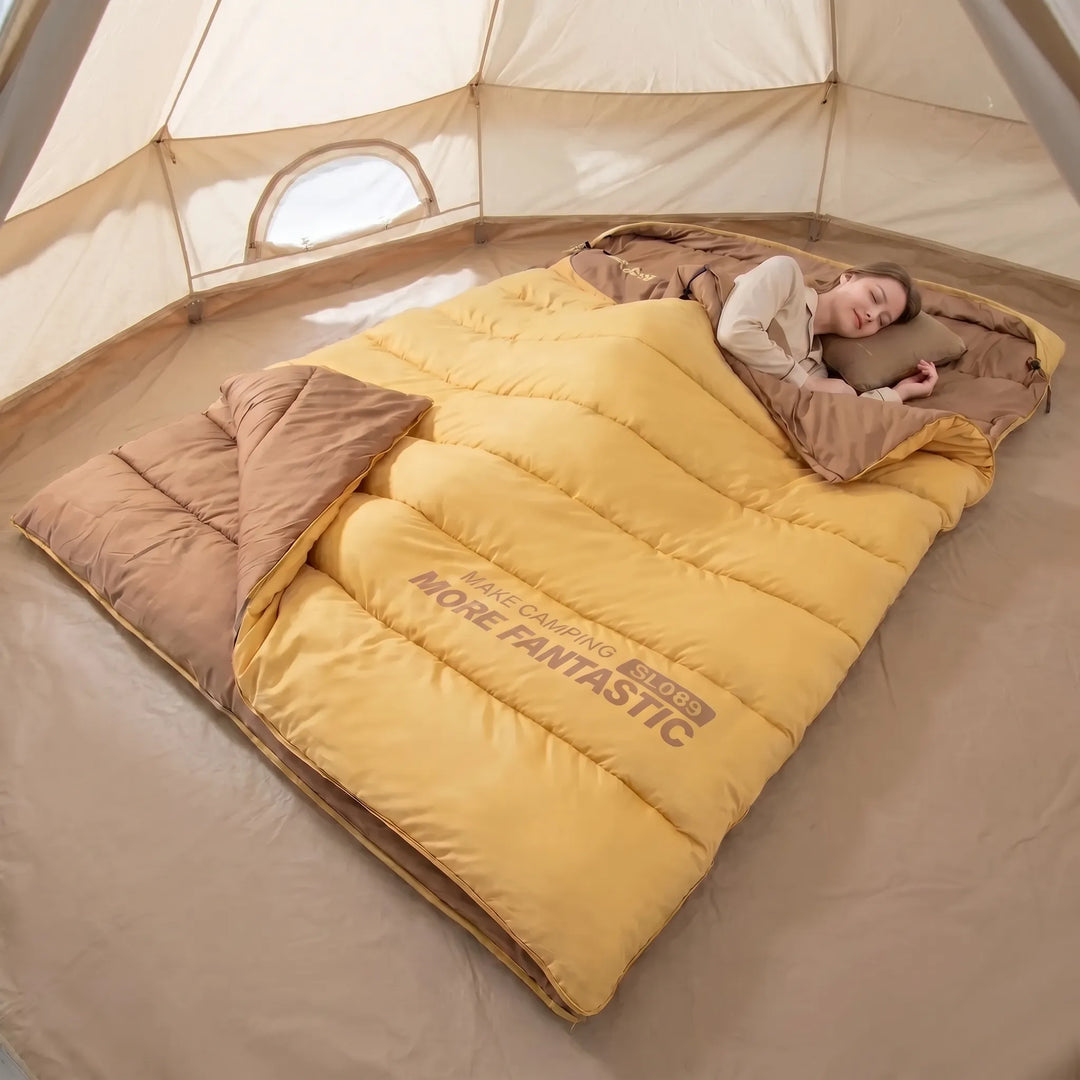 Warm yellow & brown double sleeping bag for couples camping. Insulated & portable outdoor gear for hiking & travel.