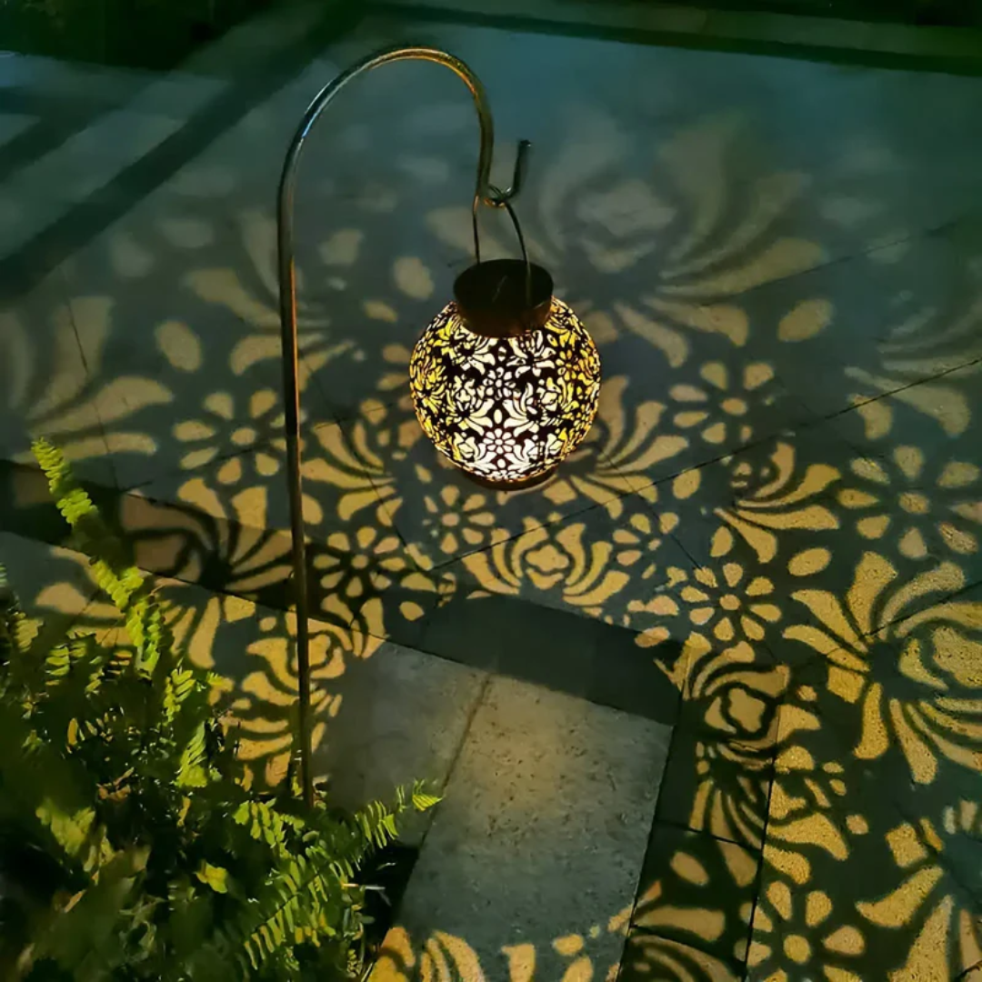 Modern solar lantern with LED light, designed to hang in gardens for decorative and energy-saving lighting.