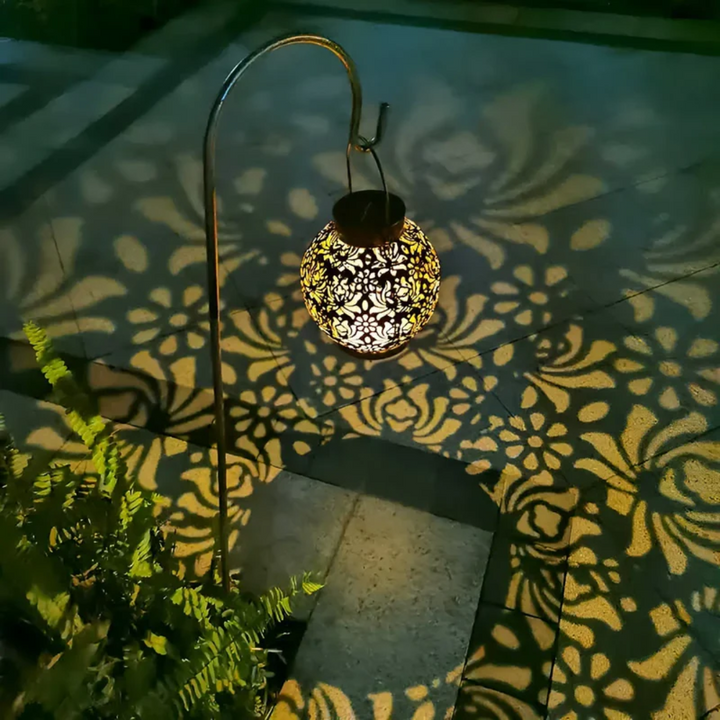 Modern solar lantern with LED light, designed to hang in gardens for decorative and energy-saving lighting.