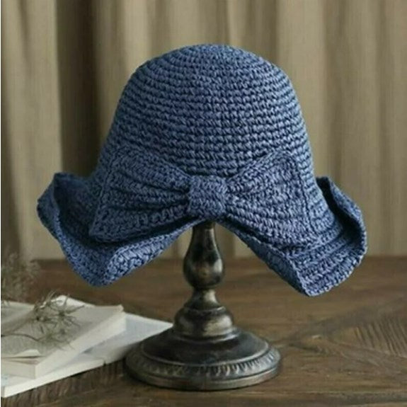Elegant women's beach hat featuring a curved brim, offering UV protection, a must-have summer accessory