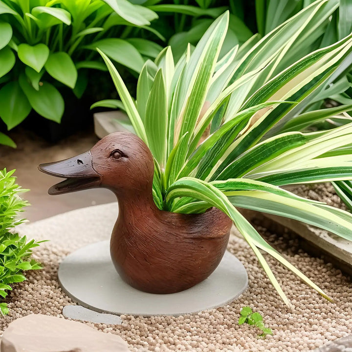 Whimsical duck statue planter pot for indoor plants, perfect for home decor, succulents, & small flowers.