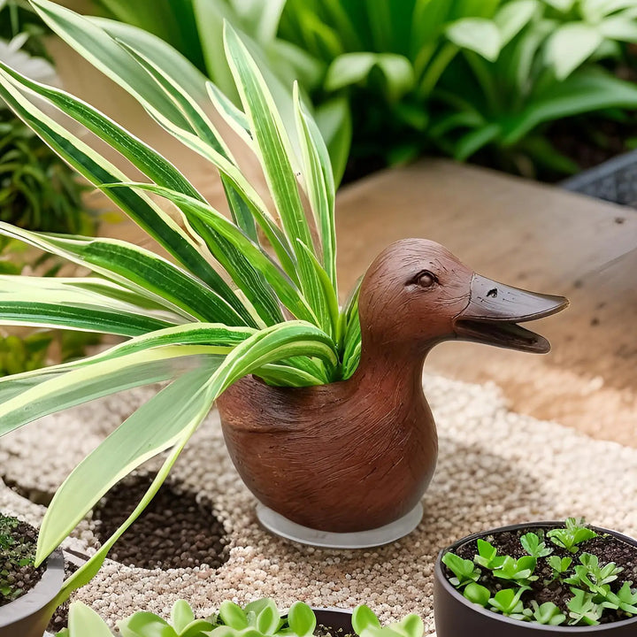 Adorable duck statue flowerpot, suitable for small indoor plants, office desks, or unique garden decor.