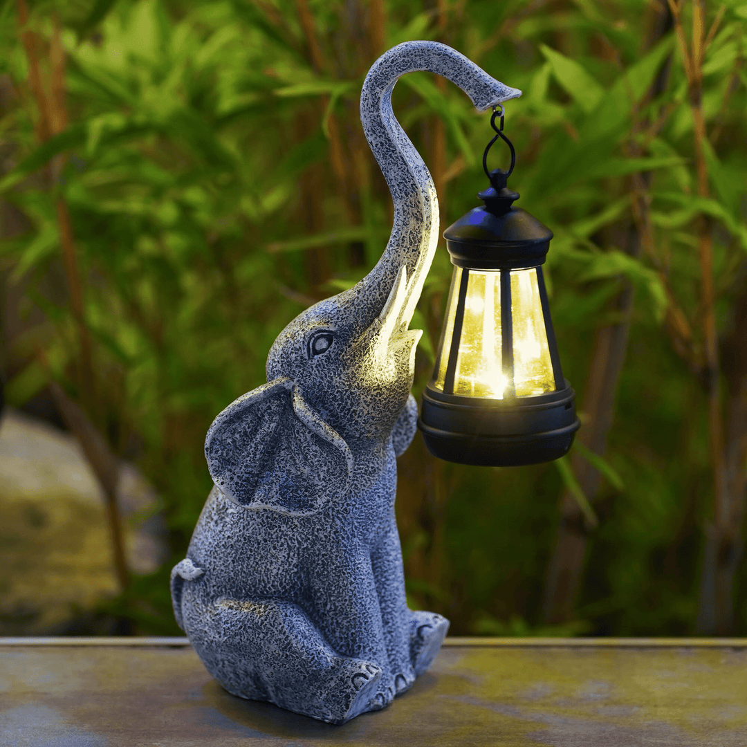 Elephant Glow solar garden lamp, a charming outdoor lighting solution & whimsical garden decor resin statue.