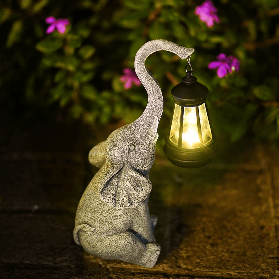 Decorative elephant solar lamp for garden & patio. Whimsical outdoor lighting resin statue adds ambient glow.